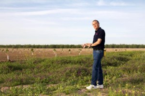 NMSU scientist David C. Johnson stands in a field at Leyendecker Plant Science Center where he is doing research on changing soil microbial community structures. Johnson's compost work suggests that the solution to global warming lies in the soil. (Courtesy photo)